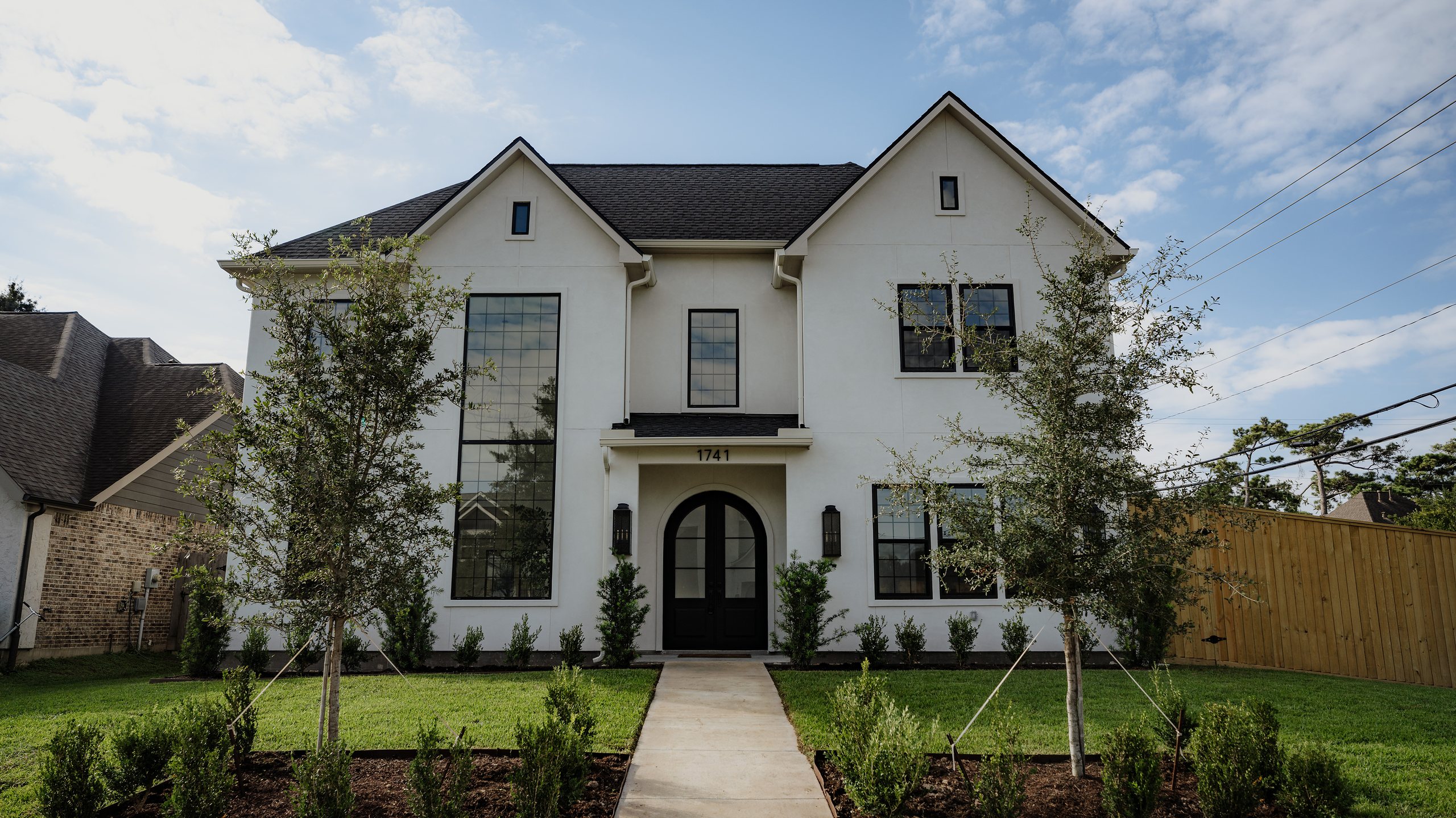 R+R Garden Oaks, a newly finished white stucco home on a tree-lined Garden Oaks street